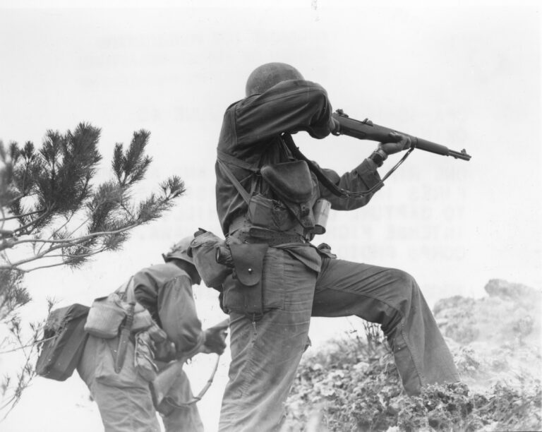Infantrymen fire rifles during the Battle of Okinawa