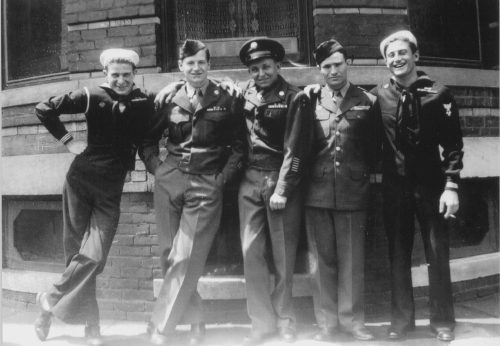 Jim Tracy standing with his four brothers all in their World War II uniforms.