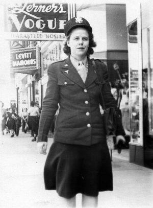 Louise Lyon in her Army nurses uniform walking down a street in Wichita, Kansas